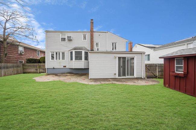 Rear view of property featuring a yard and a patio | Image 35