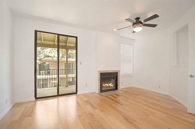 Original image of Primary Bedroom with Sliding door to upstairs Balcony overlooking the community courtyard. | Image 10