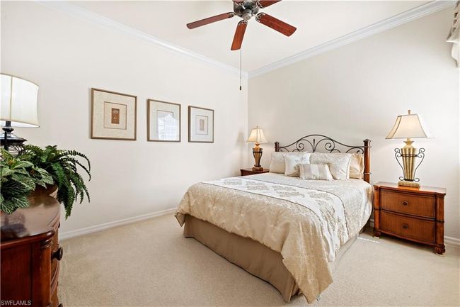 Bedroom #2 with light colored carpet, ornamental molding, baseboards, and a ceiling fan | Image 8