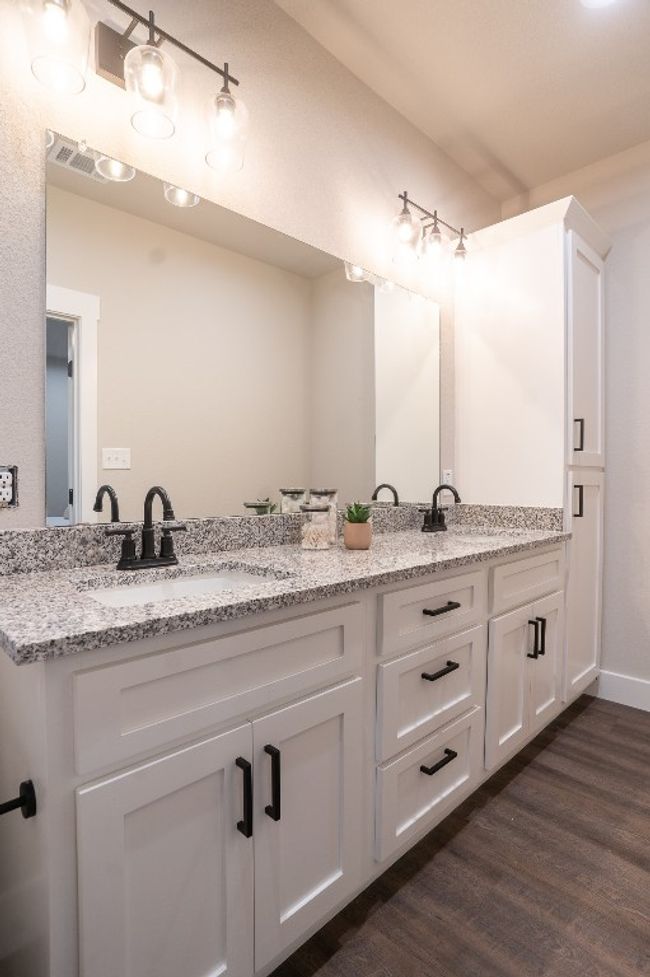 Full bath with double vanity and wood finished floors | Image 14
