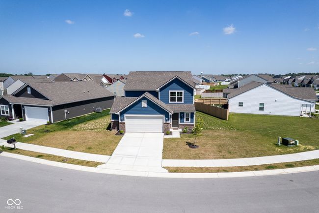 view of front of home featuring a residential view, concrete driveway, a garage, and roof with shingles | Image 42