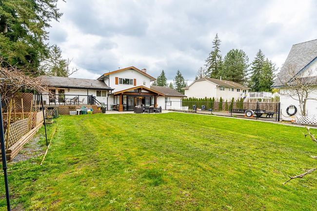 View of yard featuring a patio, a fenced backyard, and a gazebo | Image 36