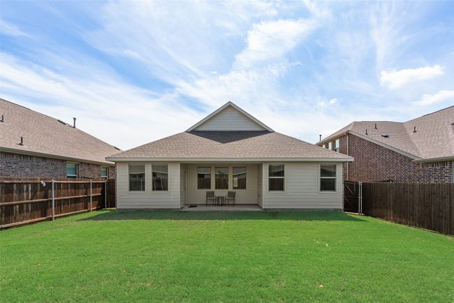 Rear view of property featuring a fenced backyard and a patio | Image 23