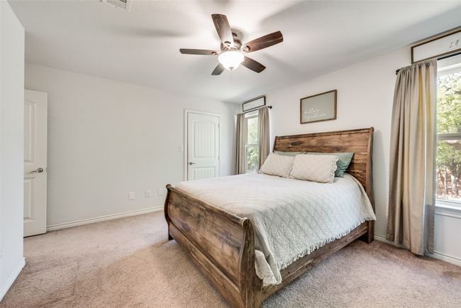 Bedroom featuring visible vents, baseboards, a ceiling fan, and carpet | Image 23