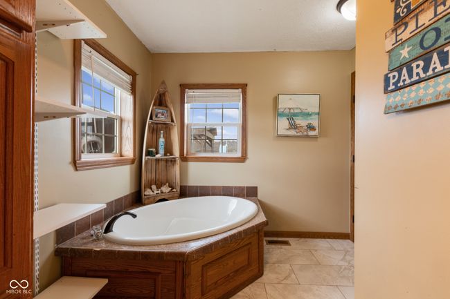 full bathroom with a bath, baseboards, and visible vents | Image 36