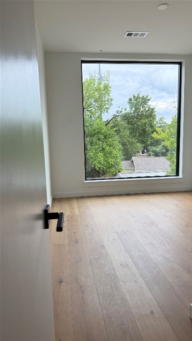 Spare room with wood finished floors and baseboards | Image 10