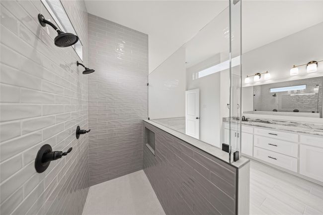 Full bathroom with tiled shower, vanity, and tile patterned flooring | Image 23