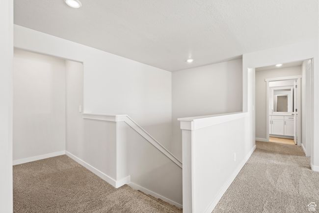 Hall featuring an upstairs landing, carpet flooring, recessed lighting, and baseboards | Image 23