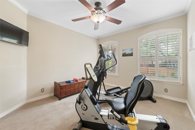 Main level bedroom currently being used as a work out area. | Image 18