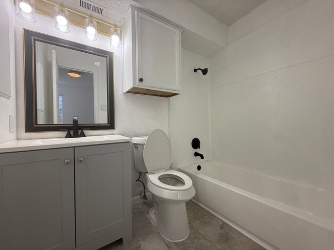 Full bath featuring vanity, tub / shower combination, and tile patterned floors | Image 14