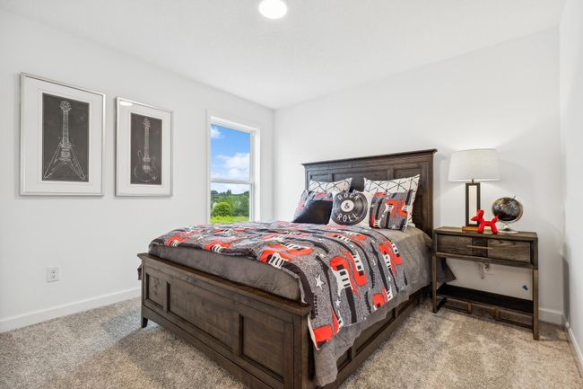 (Photo of a decorated model, actual homes finishes will vary) The upper level has 3 spacious secondary bedrooms! | Image 18