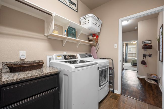 Laundry room with separate washer and dryer and dark wood finished floors | Image 14
