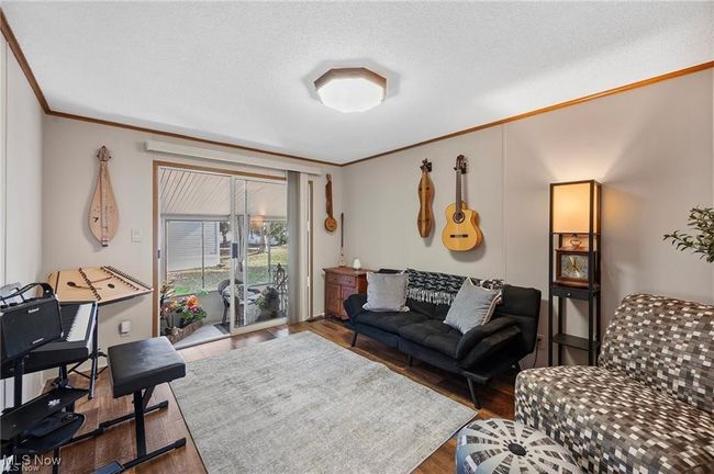 Living room featuring ornamental molding and wood finished floors | Image 5