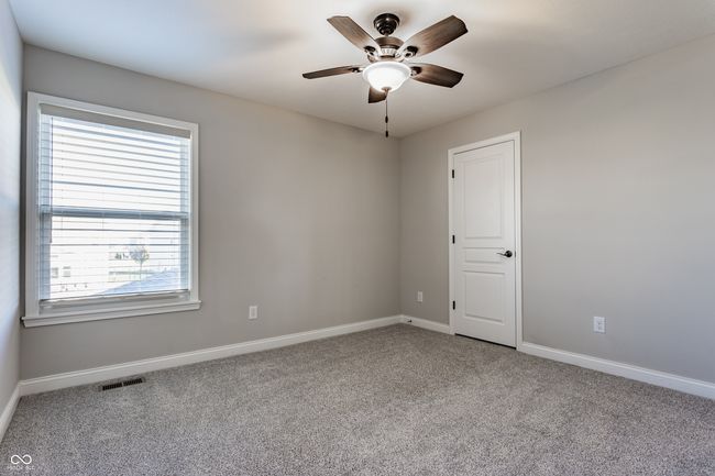 unfurnished room with ceiling fan, carpet floors, visible vents, and baseboards | Image 33