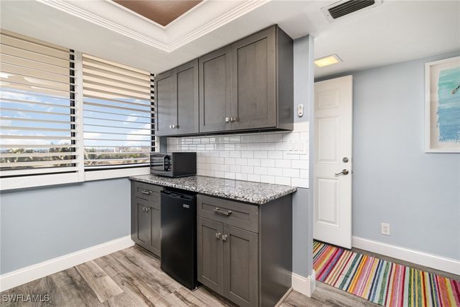 ADDITIONAL CABINETRY W/GRANITE COUNTERTOP AND BUILT-IN FREEZER. FULL-HEIGHT SUBWAY TILED BACKSPLASH. PLANTATION SHUTTERS. | Image 11
