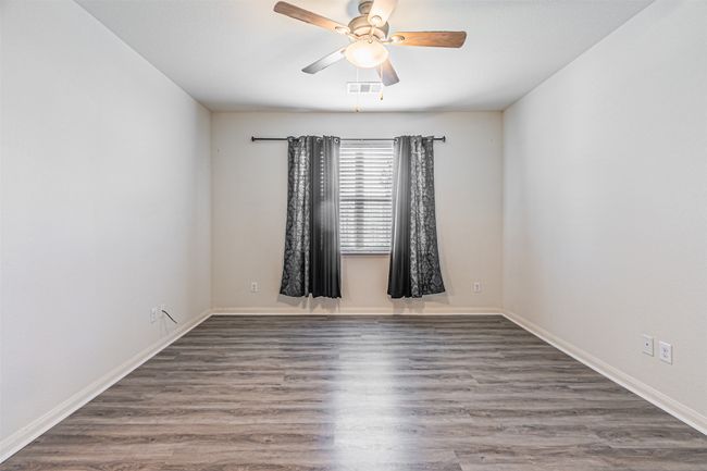 Spare room with ceiling fan, wood finished floors, and baseboards | Image 17