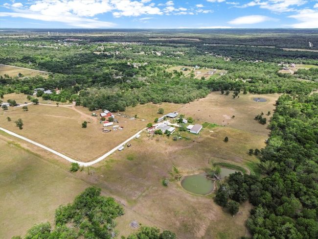 Tucked away on nearly 37 acres of peaceful Texas countryside, this one-of-a-kind property offers incredible versatility with over $250, 000 in improvements and four unique structures—making it the perfect canvas for a family compound, creative retreat, or income-producing estate. | Image 32