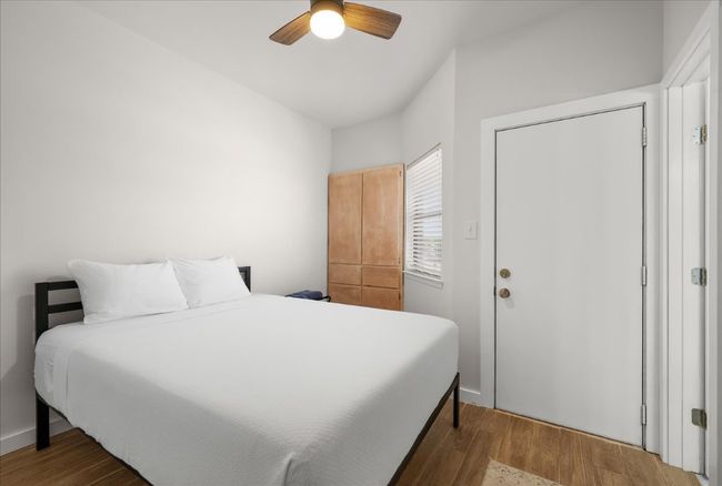 Bedroom featuring wood finished floors and ceiling fan | Image 19