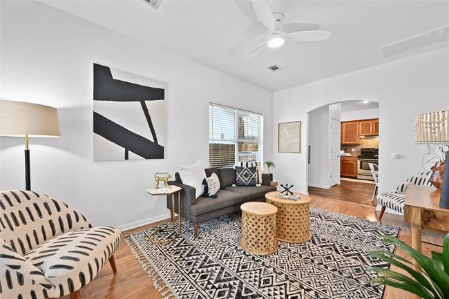 A bright and airy living room accentuated by tall ceilings. | Image 6