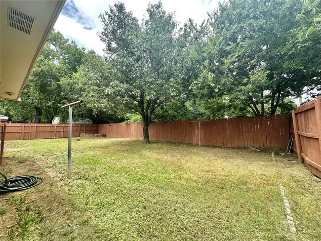 View of fenced backyard | Image 34