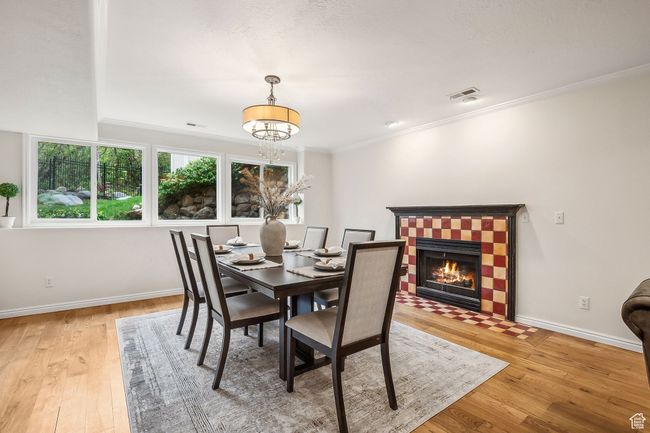 Dining area featuring wood flooring and inviting chandelier | Image 10