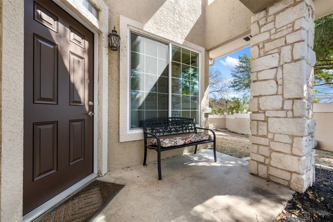Property entrance with front porch and stucco siding | Image 7