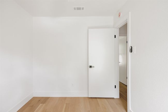 Spare room featuring light wood finished floors and baseboards | Image 30
