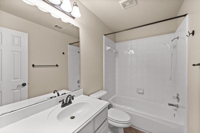 Bathroom featuring vanity and shower / washtub combination | Image 19