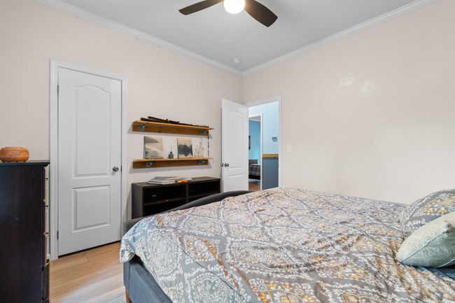 Bedroom featuring crown molding, light wood-style floors, and a ceiling fan | Image 15