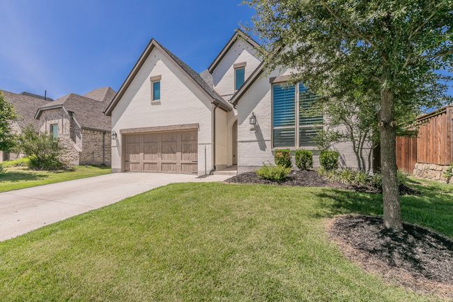 View of front facade with brick siding, driveway, and a garage | Image 28
