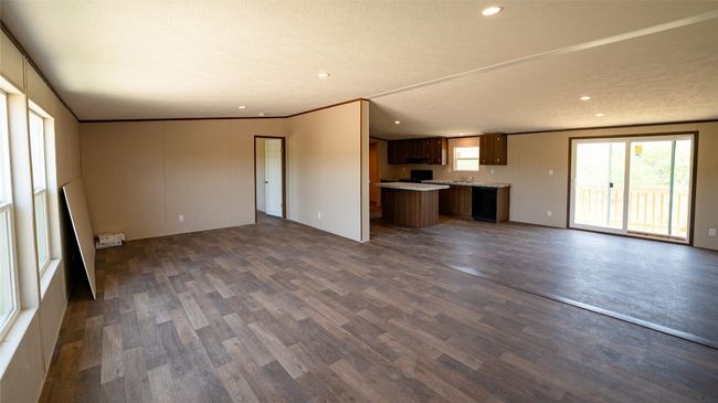 Unfurnished living room featuring dark wood-style flooring and recessed lighting | Image 30