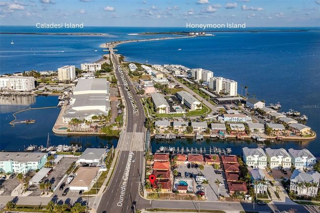 RED LOCATION DOT: 2600 N Paula Dr Unit 2B: Aerial View West to Dunedin Causeway and Honeymoon Island | Image 30