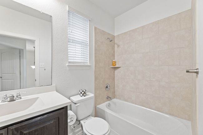 Full bathroom with toilet, vanity, and shower / tub combination | Image 28