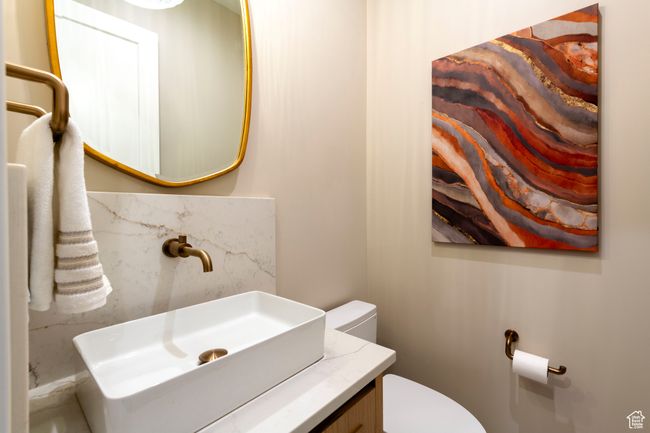 Bathroom featuring toilet and vanity | Image 25