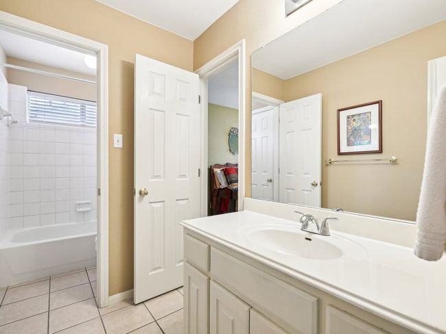 Bathroom featuring tile patterned floors, vanity, bathtub / shower combination, and baseboards | Image 27
