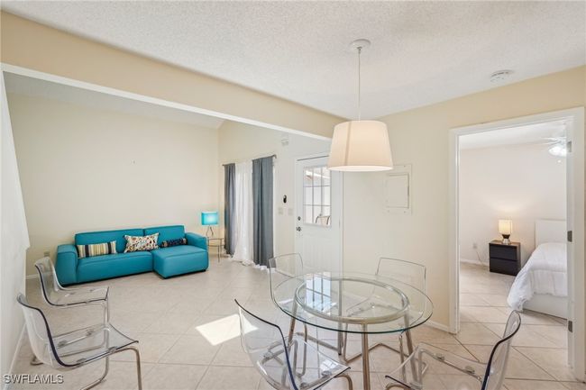 Dining space featuring tile patterned flooring and a textured ceiling | Image 11