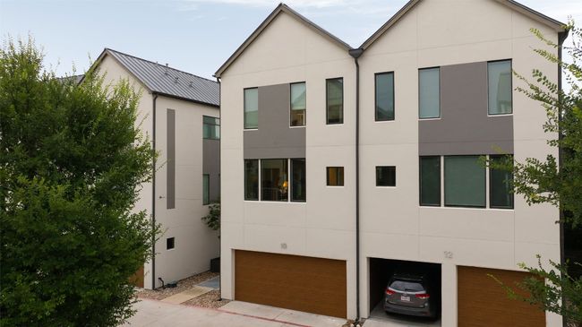 View of front of property with a garage, stucco siding, and driveway | Image 35