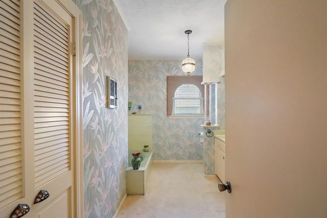 This spacious bathroom is located downstairs between the two bedrooms. | Image 22