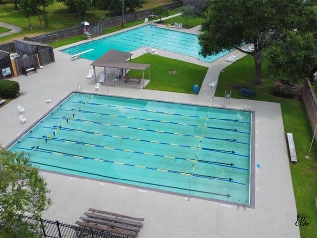 Enjoy the inviting neighborhood pool, perfect for relaxation and recreation. | Image 19