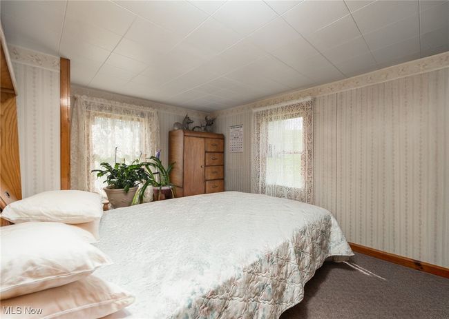 Bedroom featuring carpet, wallpapered walls, and baseboards | Image 20