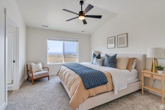 Bedroom with a ceiling fan, visible vents, carpet floors, lofted ceiling, and baseboards | Image 17