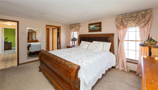 Primary Bedroom with light carpet, multiple windows, and baseboards | Image 38