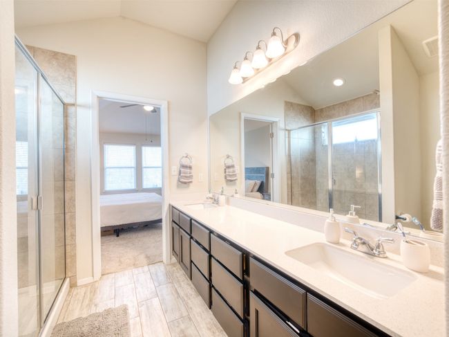 Bathroom with plenty of natural light, lofted ceiling, and vanity | Image 12