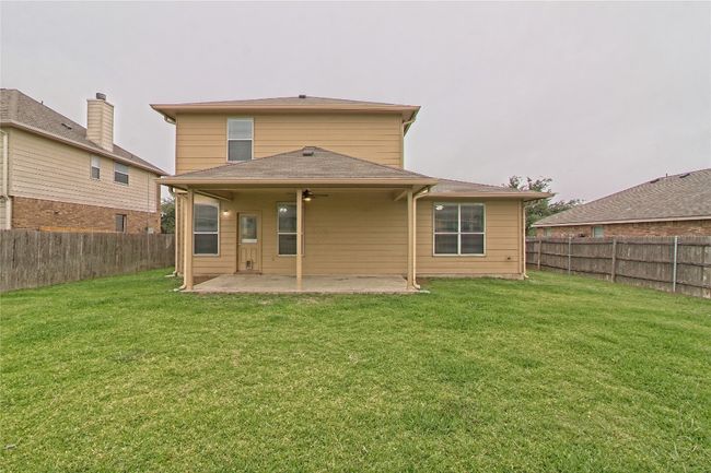 Rear view of property featuring a patio, a fenced backyard, and ceiling fan | Image 28