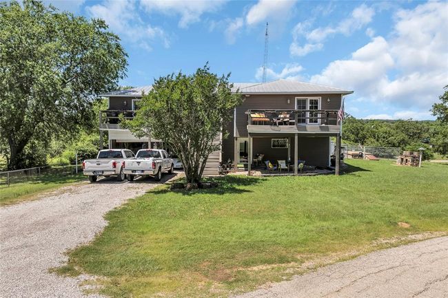 View of front of property with driveway and metal roof | Image 44