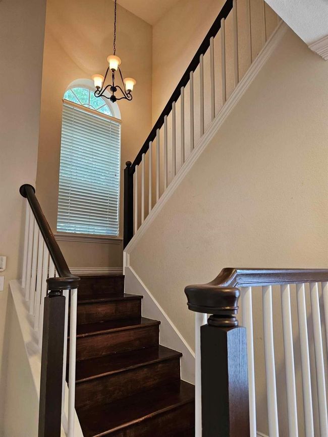 Staircase featuring a chandelier | Image 4