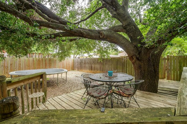 Wooden deck with a fenced backyard and outdoor dining area | Image 36