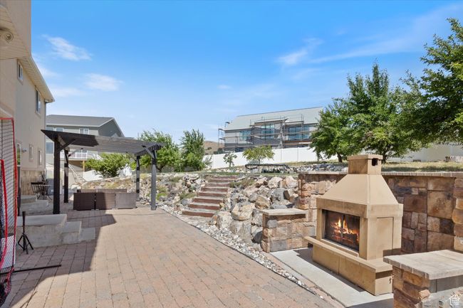 View of patio with a pergola and an outdoor living space with a fireplace | Image 28