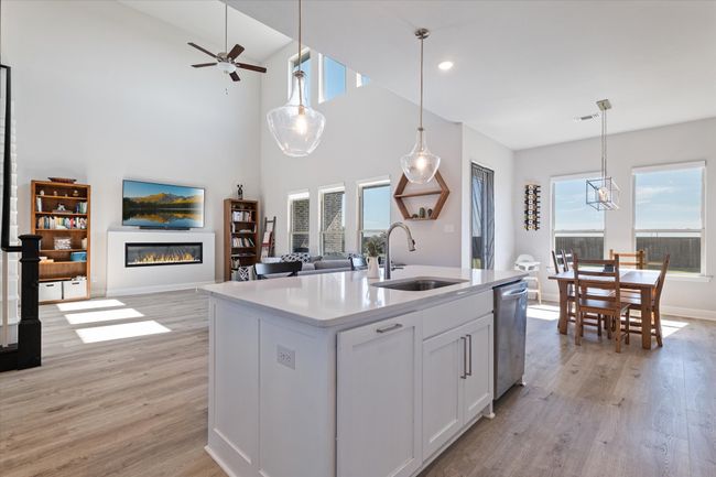 Kitchen with a sink, open floor plan, healthy amount of natural light, light wood-style flooring, and recessed lighting | Image 12
