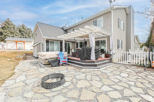 Back of house with a patio area, fence, a deck, and a pergola | Image 33